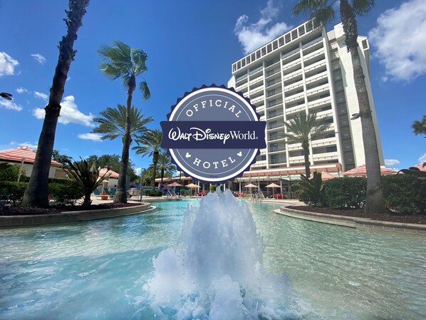 A fountain in front of a building with a sign reading 'Official Walt Disney World Hotel.'