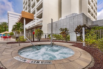 A hotel lobby with Star Wars and Disney-themed decor, including a large poster, a R2-D2 figure, and a Mickey Mouse-themed wall. at Holiday Inn Orlando - Disney Springs® Area by IHG
