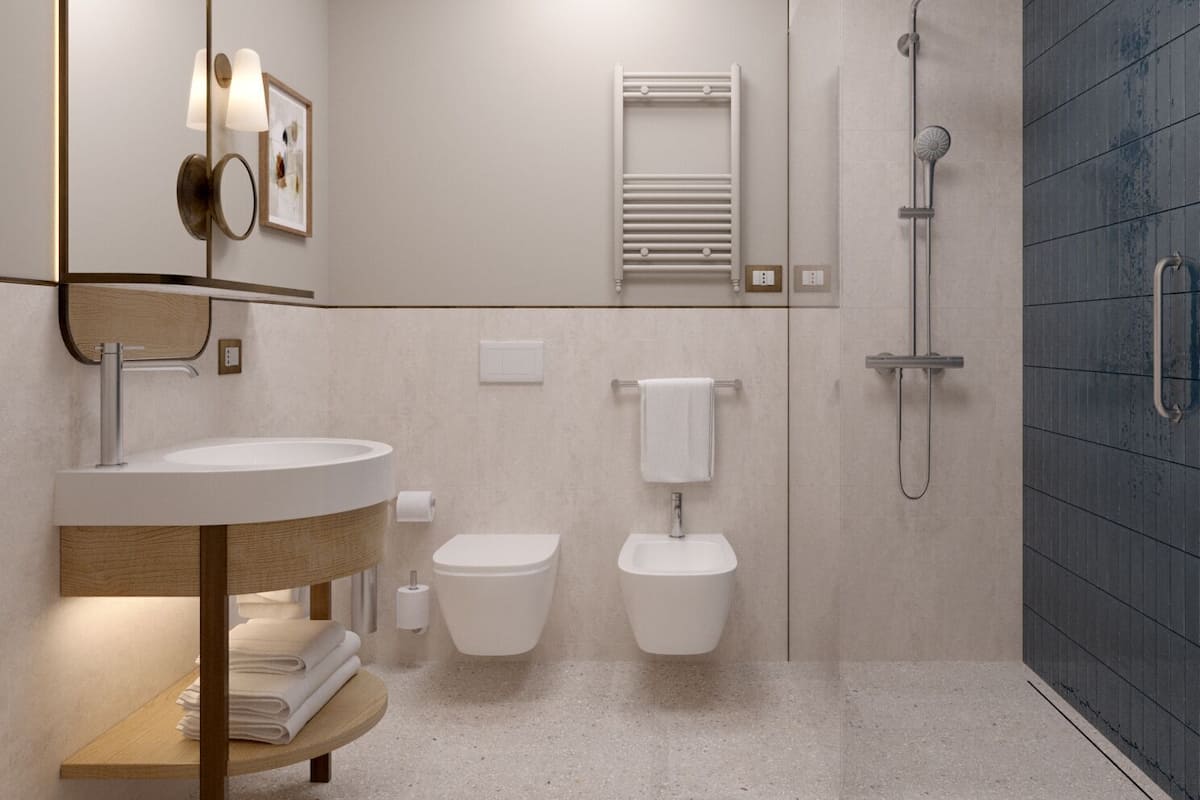 A modern bathroom with a vanity, toilet, bidet, and shower.