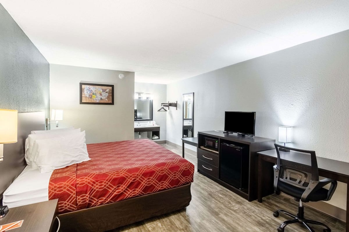 Desk, laptop workspace, blackout drapes, iron/ironing board