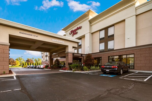 Welcome to Hampton Inn, featuring a clear entrance and ample parking with designated spaces.