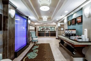 Welcome to our lobby, featuring a reception desk, comfortable seating area, and decorative rug.