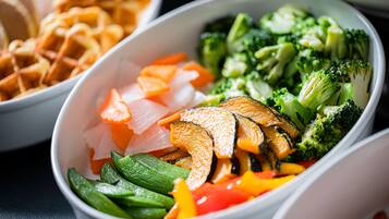 A bowl of mixed vegetables including broccoli, carrots, and zucchini.