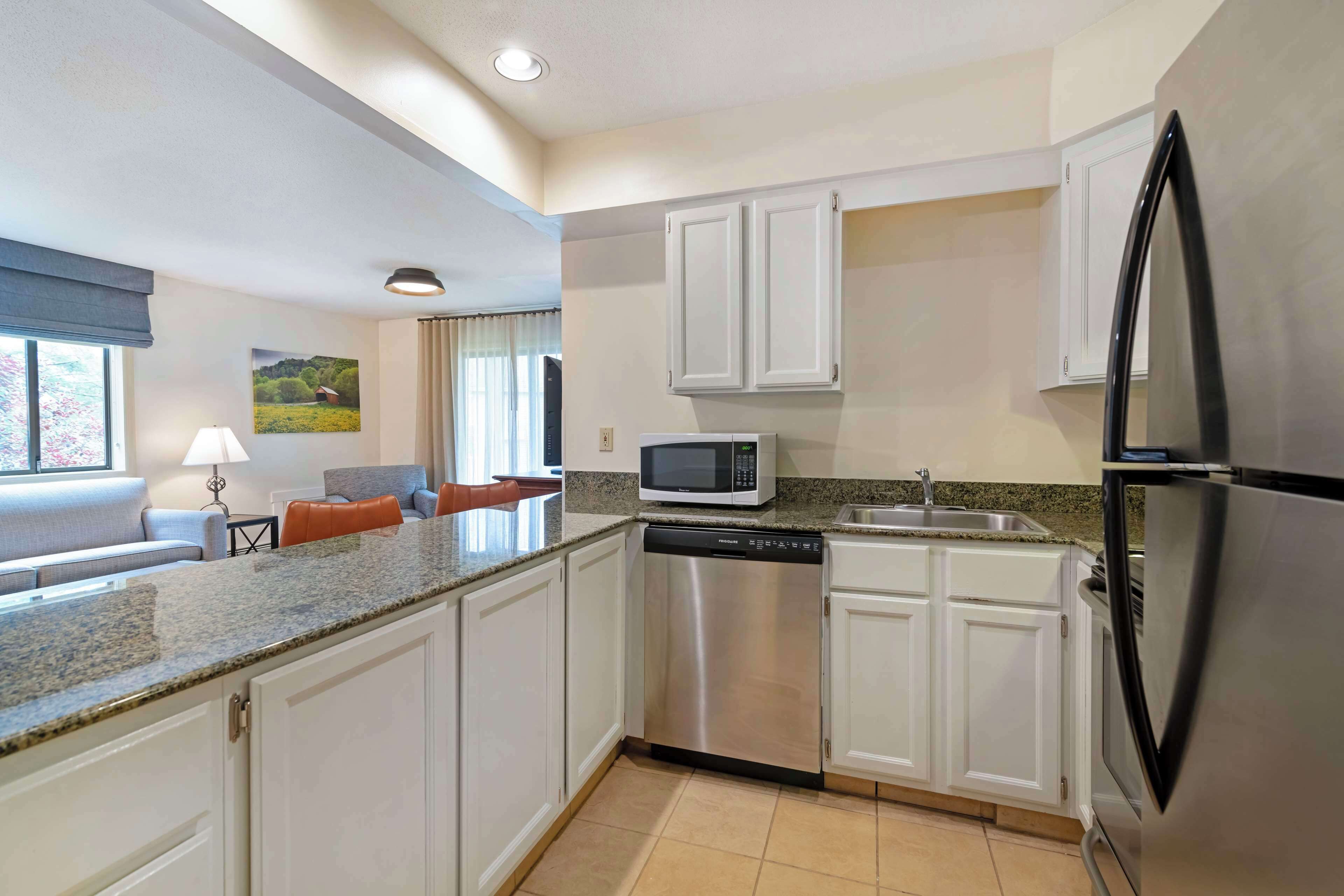 suite, 2 queen beds, non smoking, kitchen (third bed is a sofabed) | blackout curtains, iron/ironing board, bed sheets