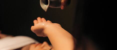 A person receiving a foot treatment with a cup.