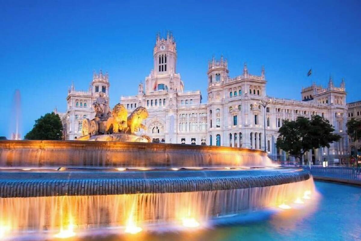 A grand building with a large fountain in front.