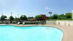 A swimming pool with lounge chairs and a lifeguard stand. - Hampton Inn Dalton (Dalton)