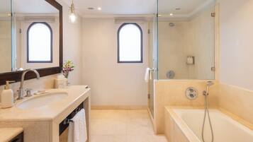 Un baño moderno con un espejo grande, una bañera y una ducha.