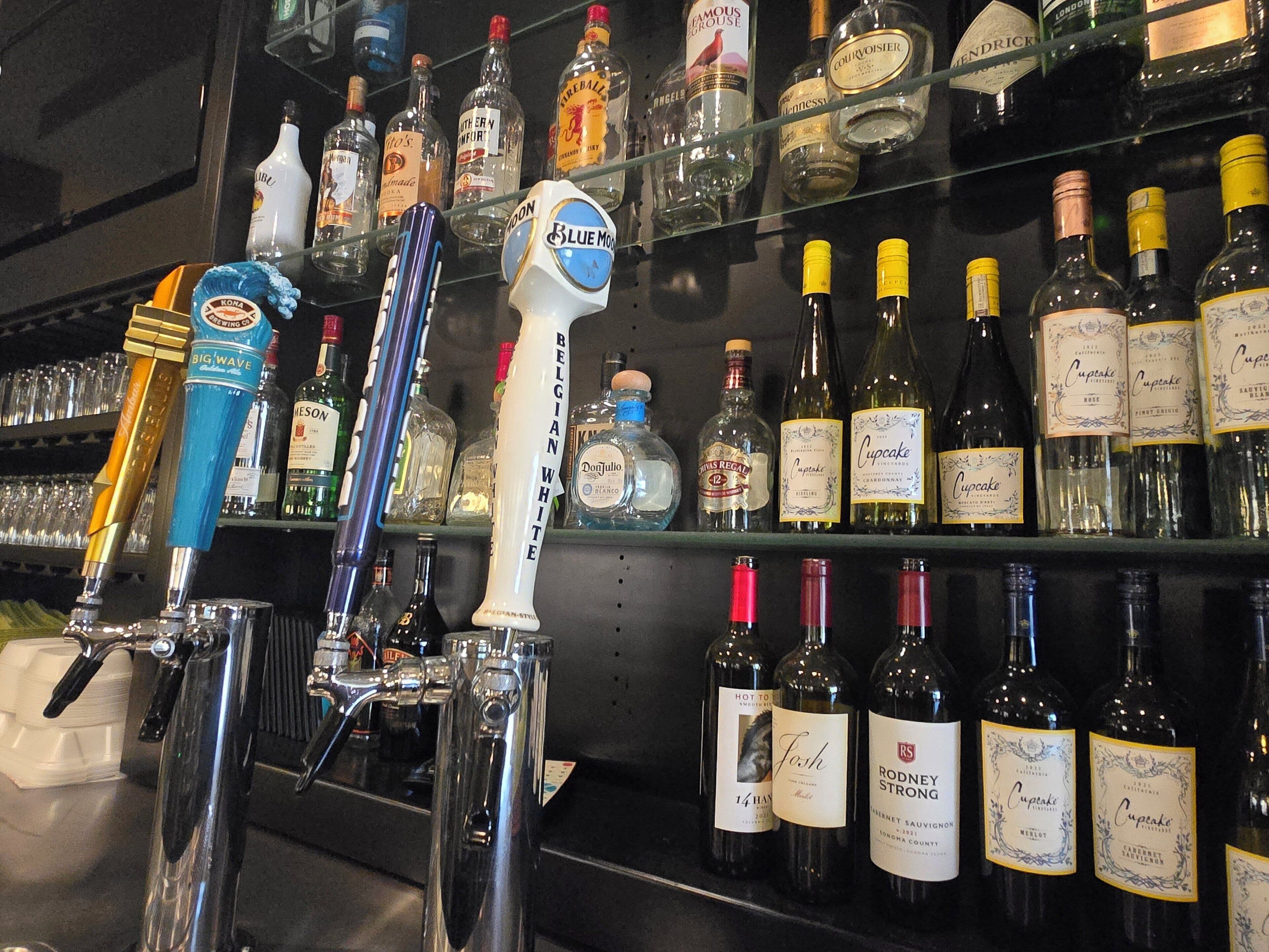 A bar area with various liquor bottles and a tap system.