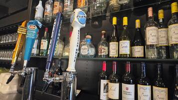 A bar area with various liquor bottles and a tap system.