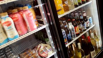A refrigerated display case with various beverages including milk, juice, and beer.
