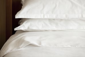 A close-up of a bed with white bedding. - Sheraton Vancouver Airport Hotel (Richmond)