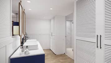 A modern bathroom with a white vanity, a mirror, and a blue accent wall.