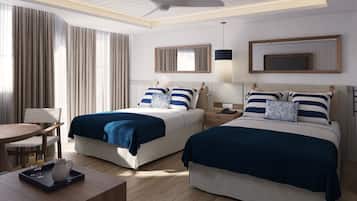 Habitación de hotel con dos camas, un escritorio con bandeja, una silla y un ventilador de techo.