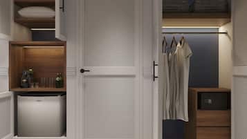 A walk-in closet with a built-in mini-fridge, shelves with bottles, and hanging clothes.