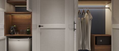 A walk-in closet with a built-in mini-fridge, shelves with bottles, and hanging clothes.