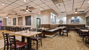 Enjoy a meal in our restaurant with a variety of seating options, including tables, booths, and a communal area.