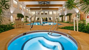 Relax by the pool, surrounded by a spacious deck and comfortable seating areas.