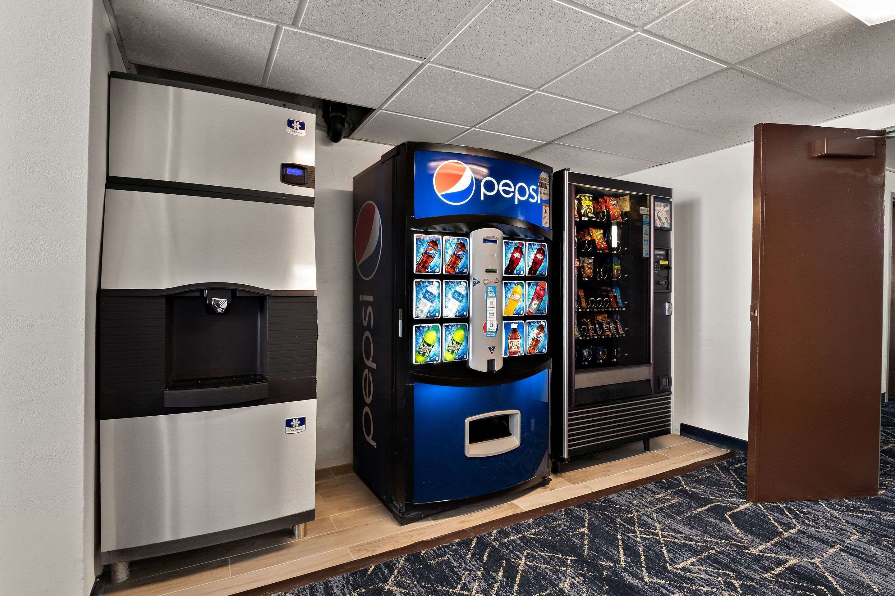 A vending machine area with a Pepsi dispenser, a water dispenser, and a snack vending machine.