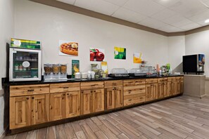 A buffet area with wooden cabinets and a refrigerated display case.