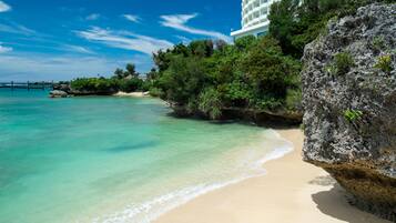 On the beach, white sand, free beach shuttle, beach umbrellas