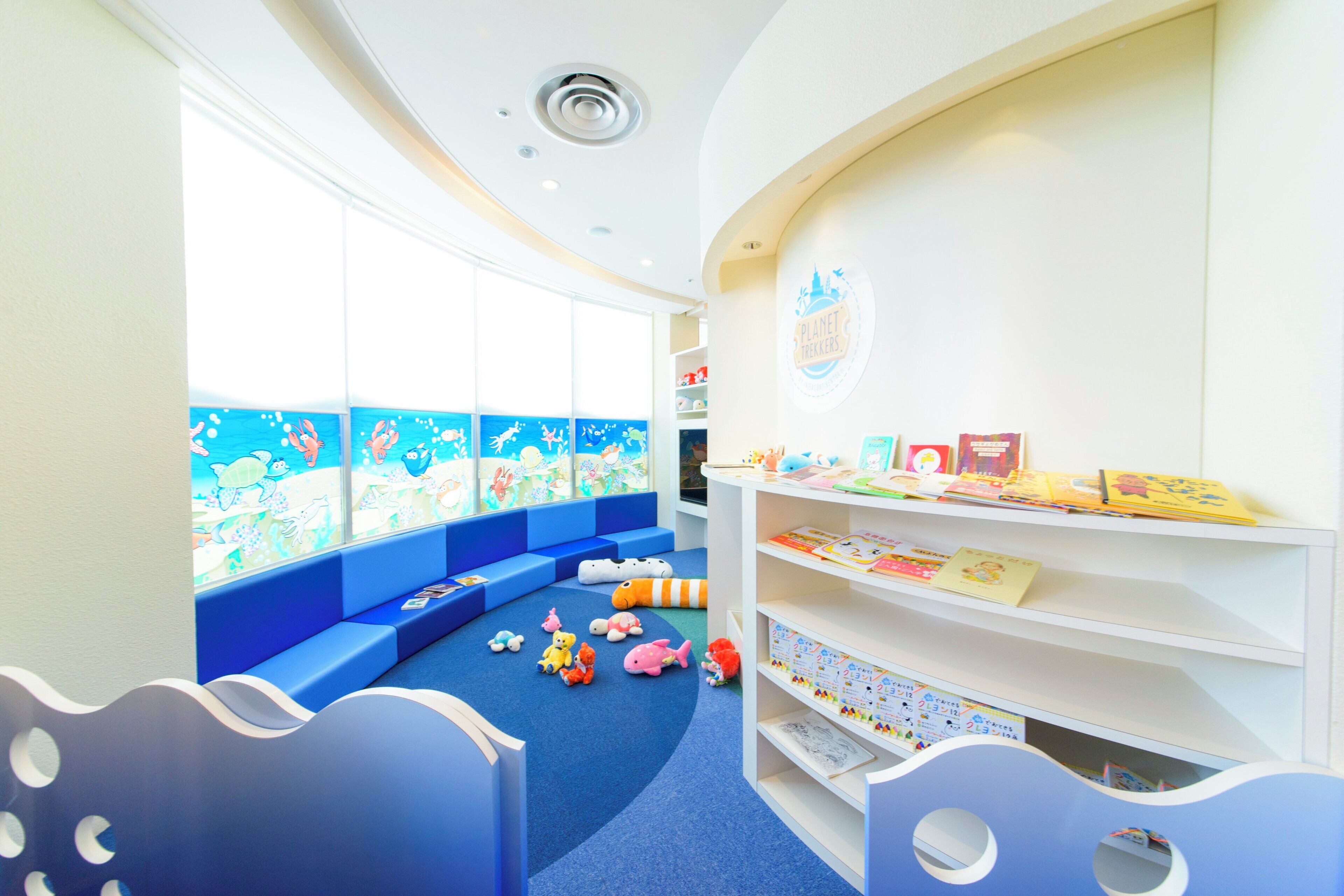 A children's play area with seating and bookshelves.
