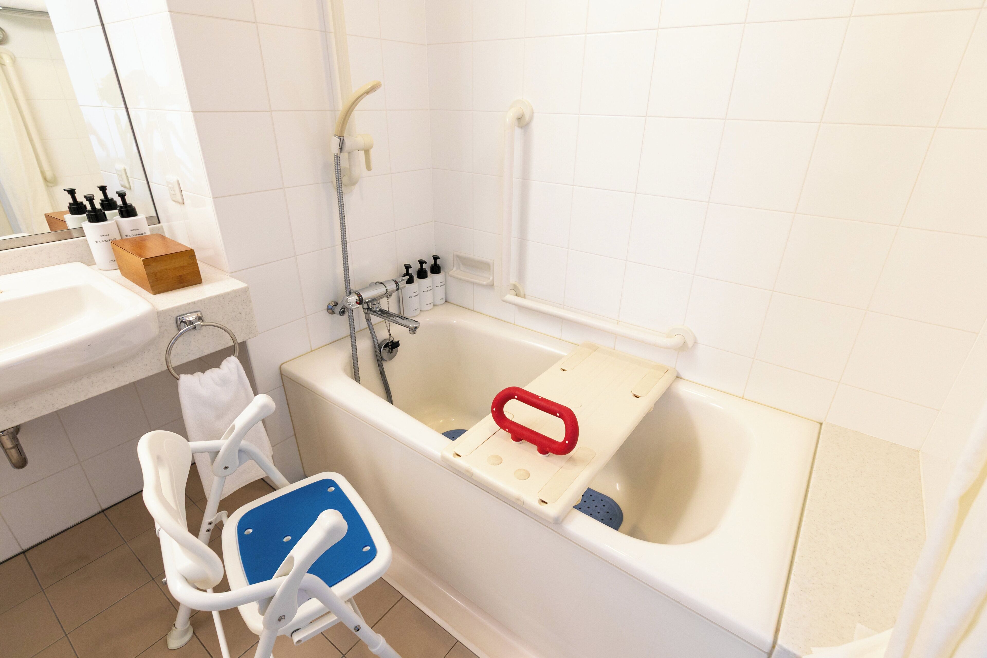 A bathroom with a bathtub, a shower, a sink, and a baby changing station.