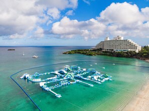 On the beach, white sand, free beach shuttle, beach umbrellas