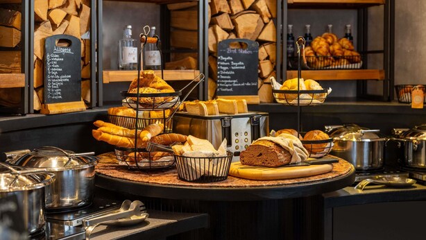 A breakfast buffet with various breads, pastries, and beverages. - Hotel Mercure Wien Zentrum (Vienna)