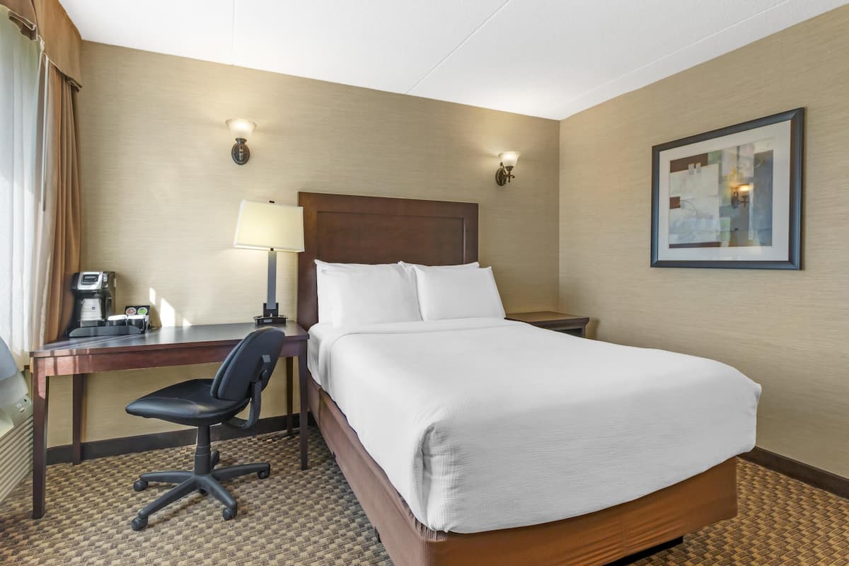 Premium bedding, desk, laptop workspace, iron/ironing board