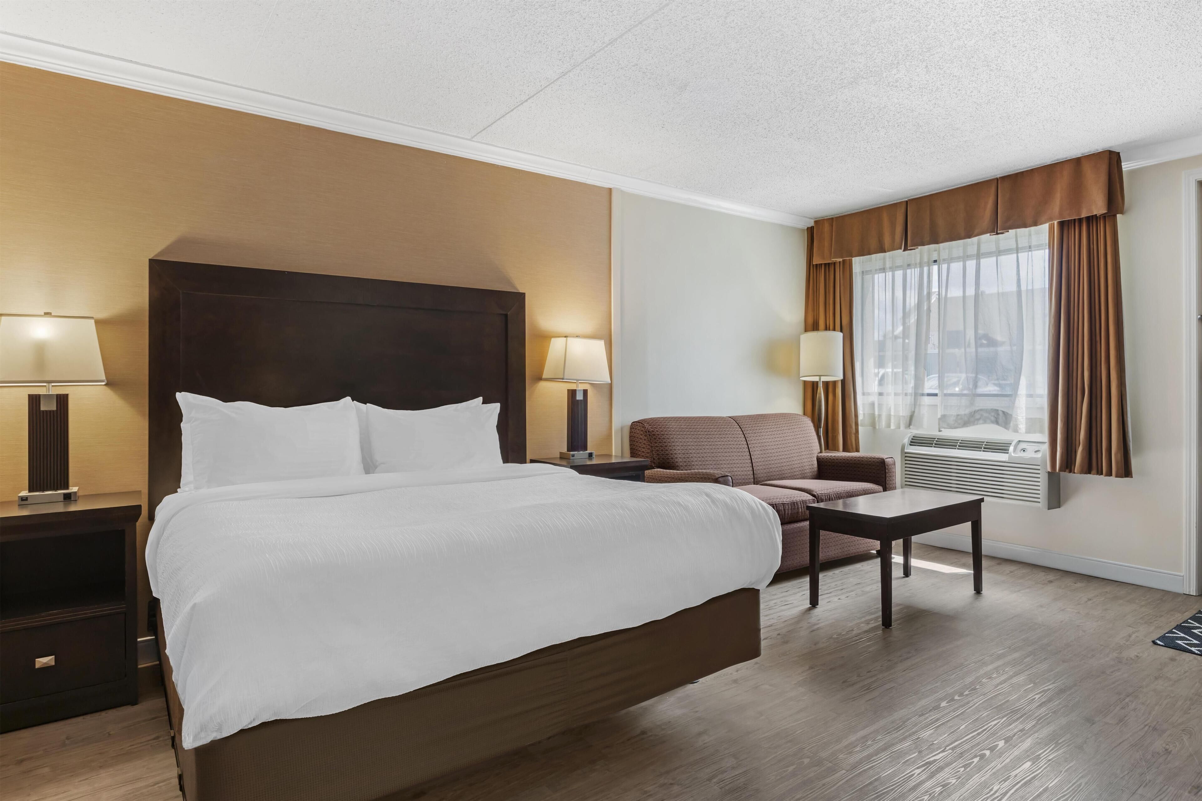 Suite, 1 King Bed, Non Smoking, Refrigerator & Microwave (Larger Room;with Sofabed) | Premium bedding, desk, laptop workspace, iron/ironing board