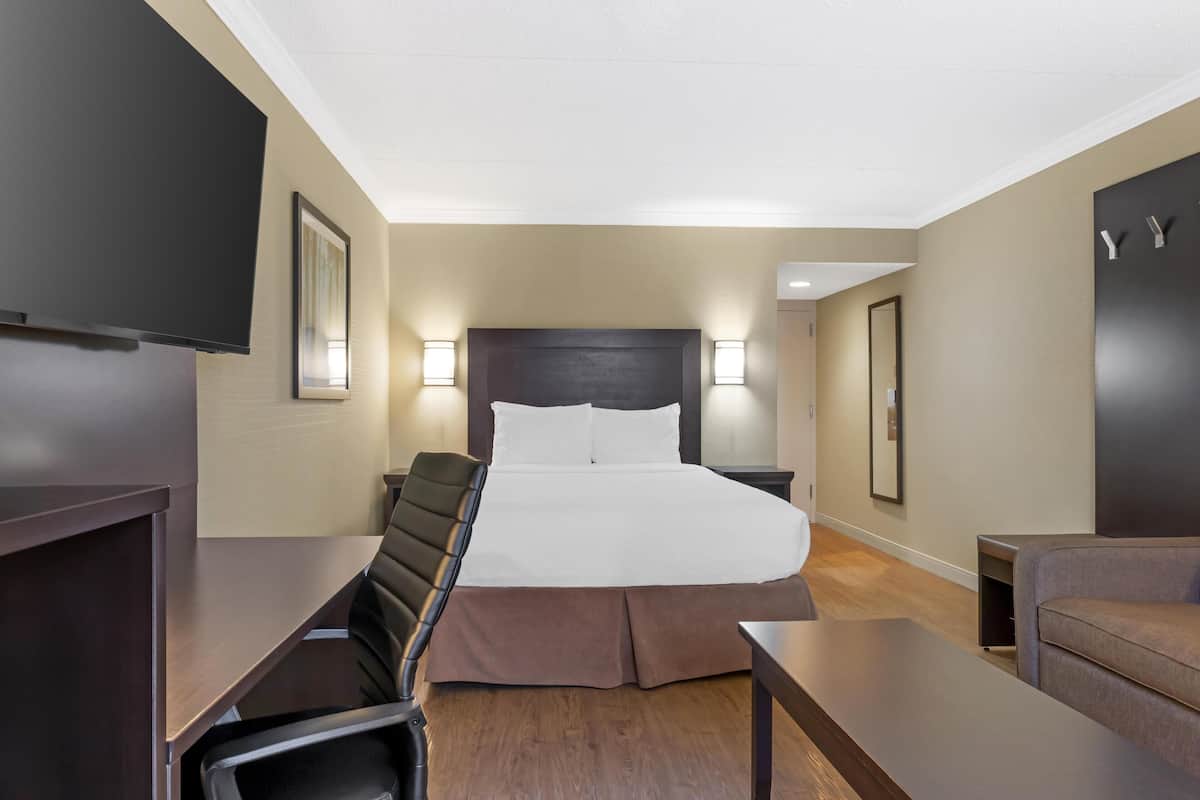 Premium bedding, desk, laptop workspace, iron/ironing board
