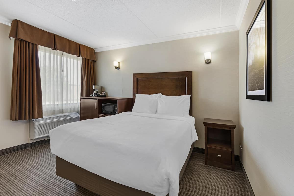 Premium bedding, desk, laptop workspace, iron/ironing board