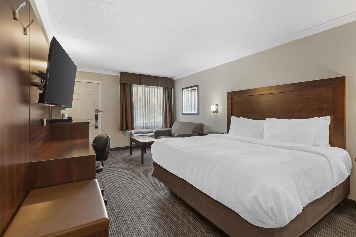 Premium bedding, desk, laptop workspace, iron/ironing board