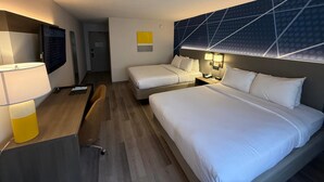 A hotel room with two beds, a desk with a lamp, a TV, and a wall-mounted light fixture. - Comfort Inn & Suites Danbury-Bethel (Danbury)