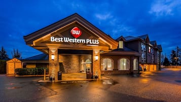 Welcome to the Best Western Plus hotel, featuring a grand entrance with stone pillars and a large archway.