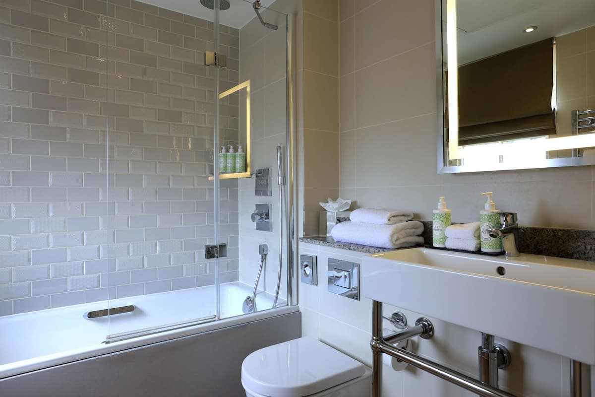 deluxe room, 1 king bed | bathroom | shower, hair dryer, towels