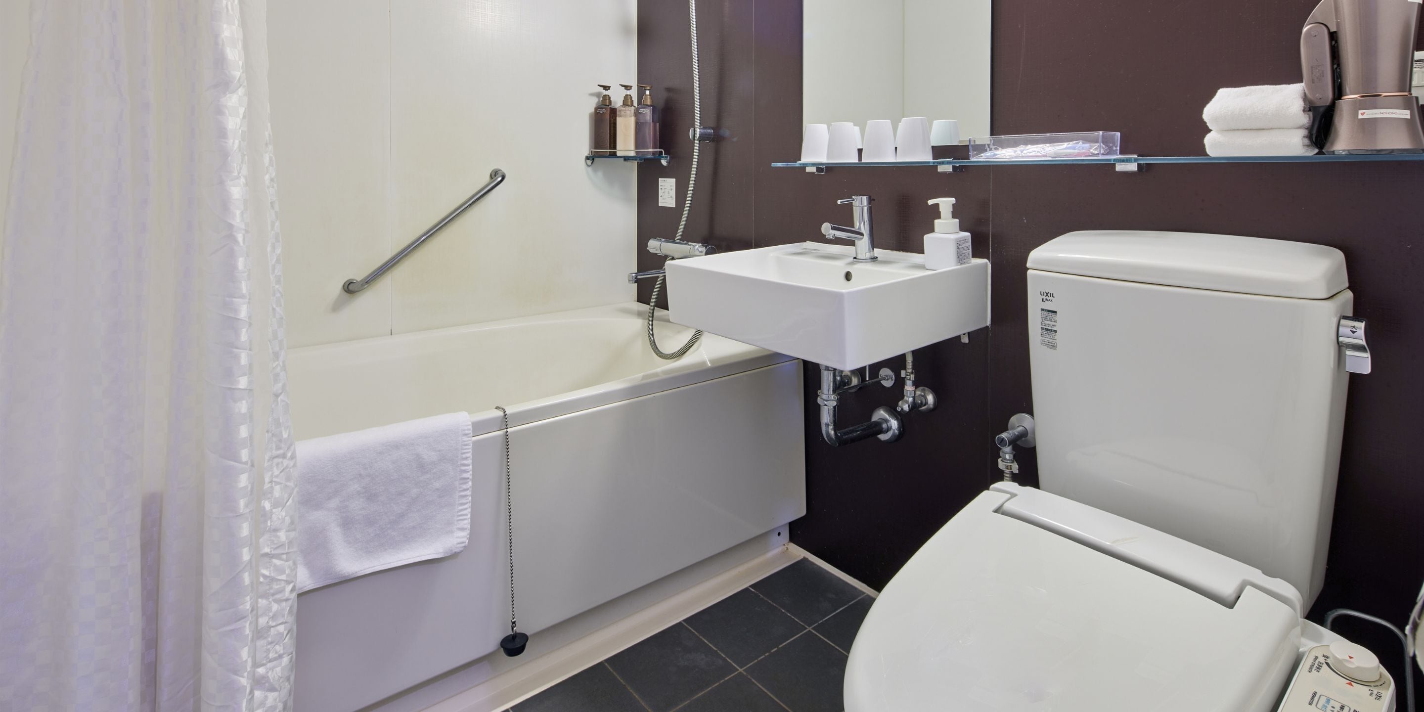 A bathroom with a bathtub, a sink, and a toilet.