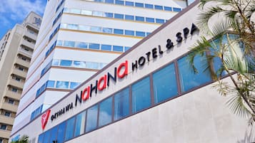 A modern hotel building with a prominent sign for "Okinawa Hotel & Spa".