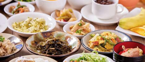 A variety of dishes on a table, including rice, vegetables, and meat.