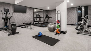 A modern gym with cardio machines, free weights, and a large exercise ball. - La Quinta Inn Lexington/Horse Park (Lexington)