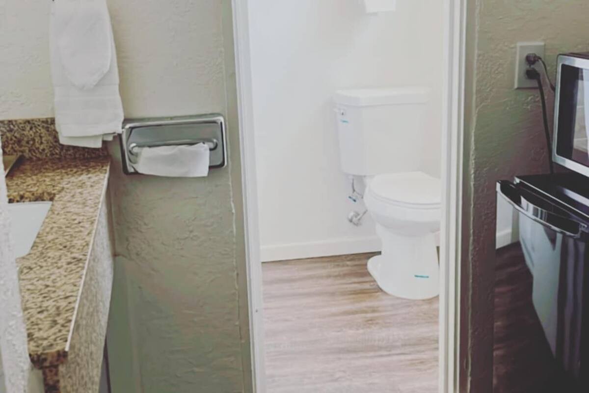 suite, 1 king bed, non smoking | bathroom | rainfall showerhead, free toiletries, hair dryer, towels