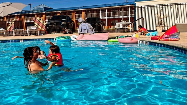 Seasonal outdoor pool, open 9:00 AM to 10:00 PM, pool umbrellas