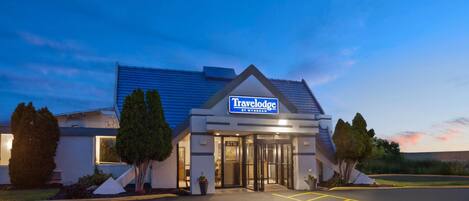 A Travelodge hotel with a modern design, featuring a prominent entrance and a parking area.