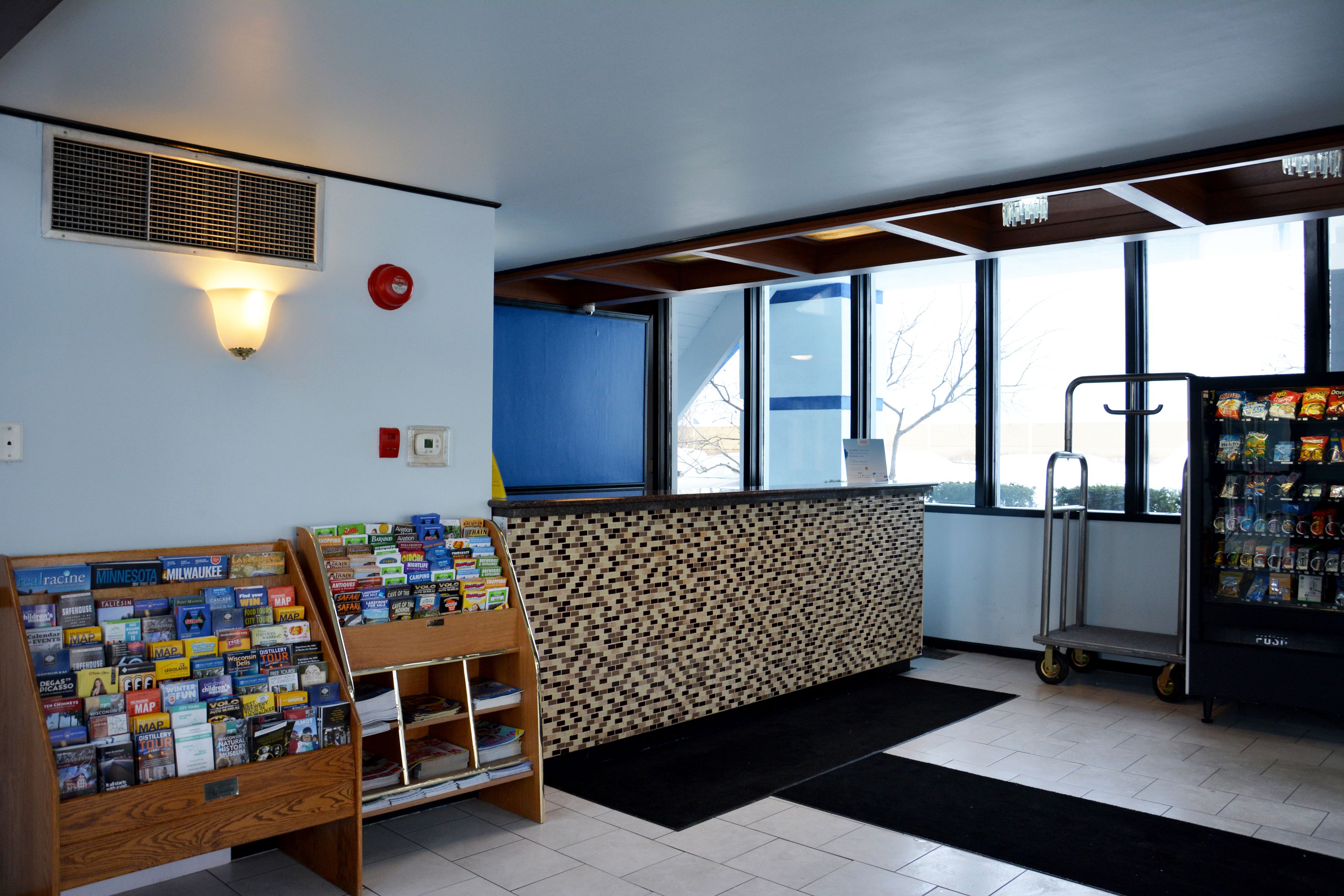 A reception area with a map display, a vending machine, and a window with a view of the outside.