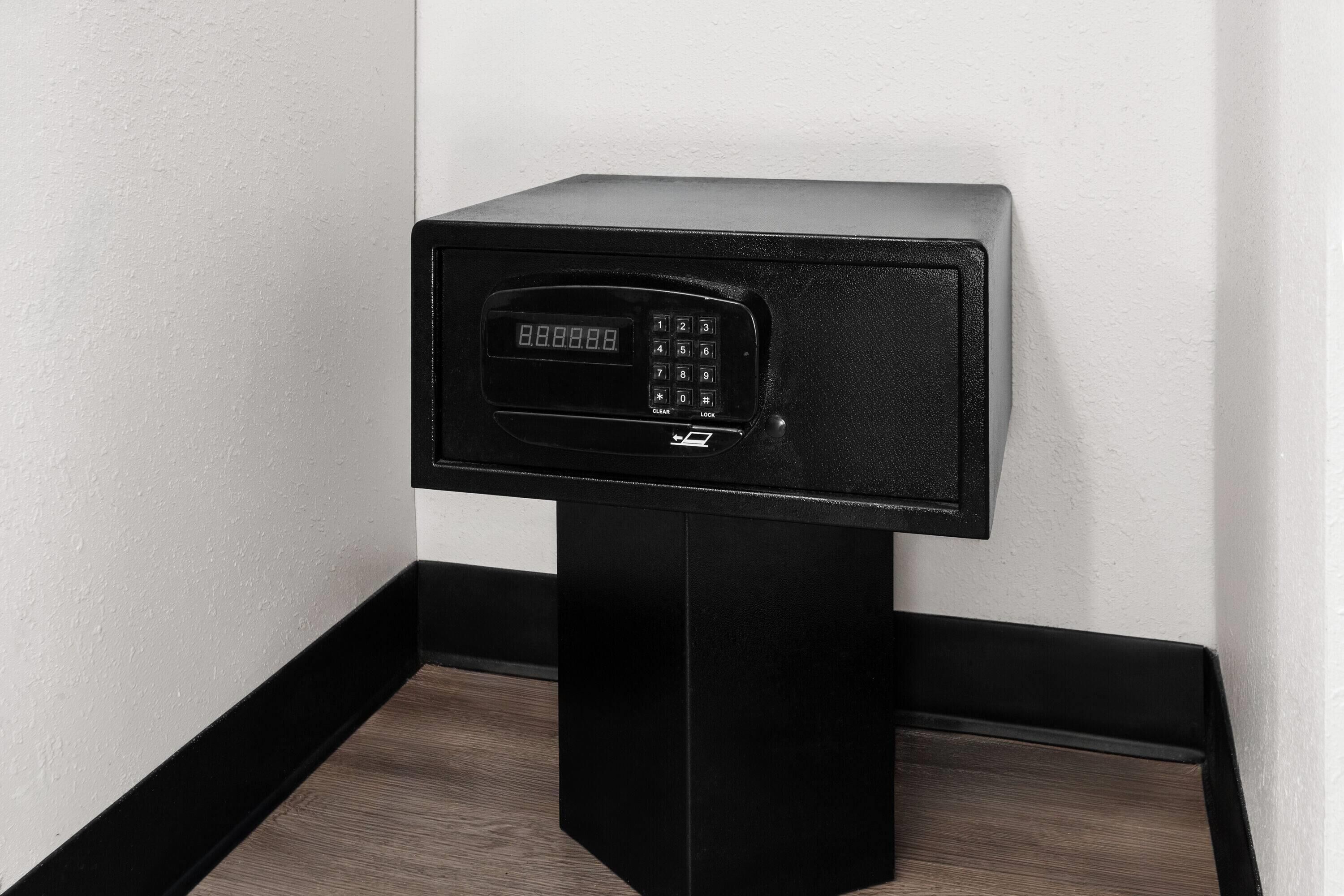 Un coffre-fort électronique noir, fixé au mur et doté d’un clavier numérique.
