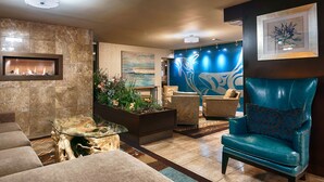A modern living room with a fireplace, comfortable seating, and decorative plants. - Best Western Plus Inner Harbour (Victoria)