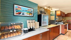 A modern kitchen with a coffee station, a fan, and a decorative wall. - Best Western Plus Inner Harbour (Victoria)