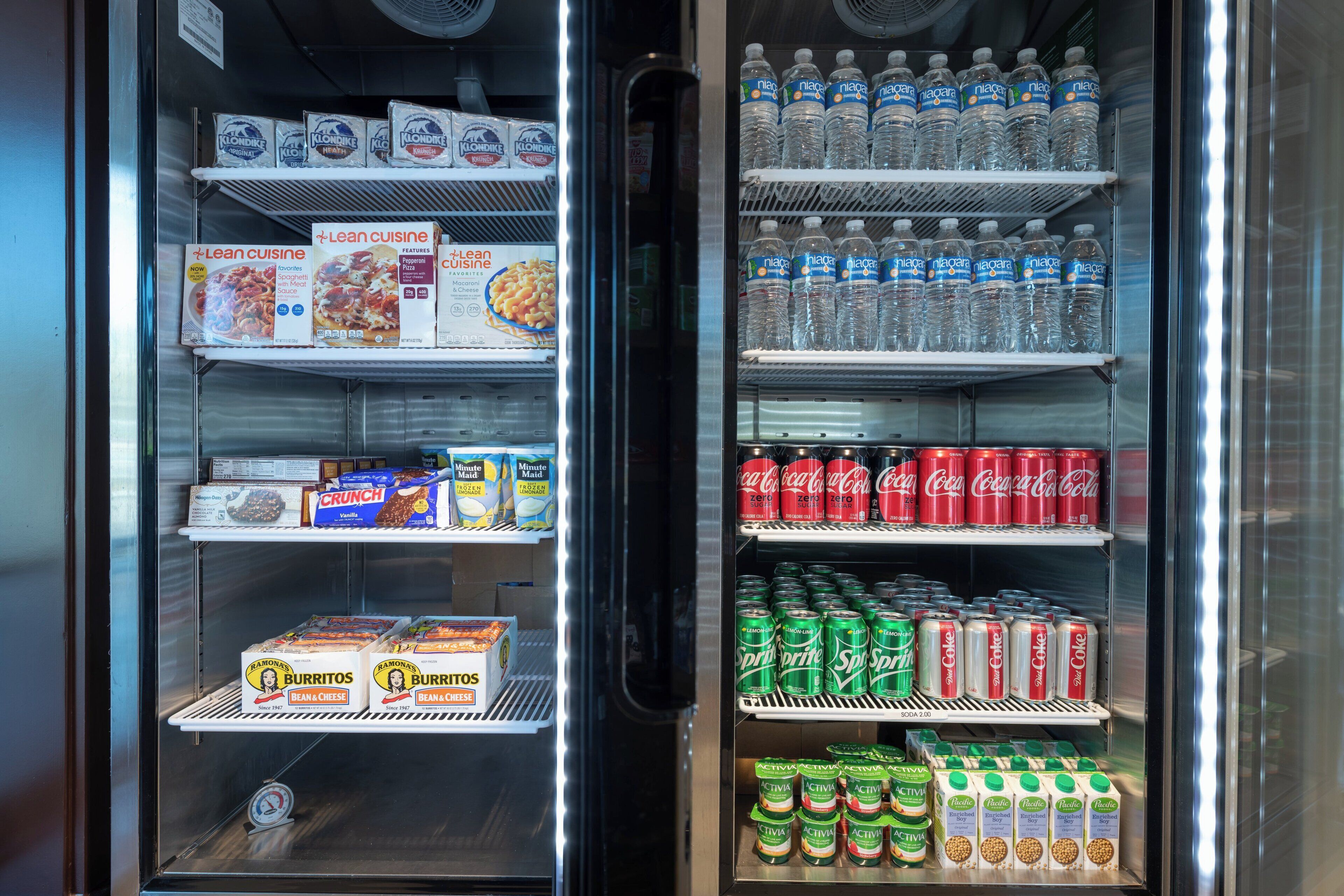 A refrigerated display case with various food and drink items.