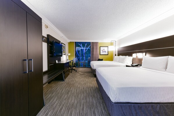 A hotel room with a large bed, a desk with a chair, a television, and a window with a view of trees. - Holiday Inn Express Mill Valley San Francisco Area by IHG (Mill Valley)